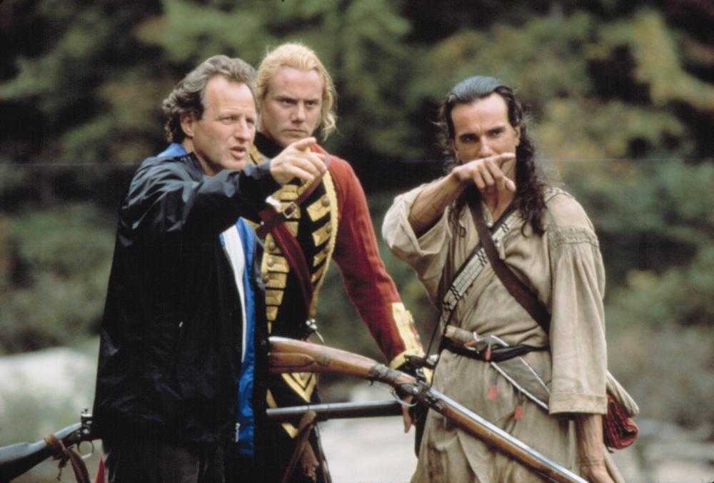 Micahel Mann discusses the next set-up with Daniel Day Lewis and Steven Waddington on location for The Last of the Mohicans (1992)