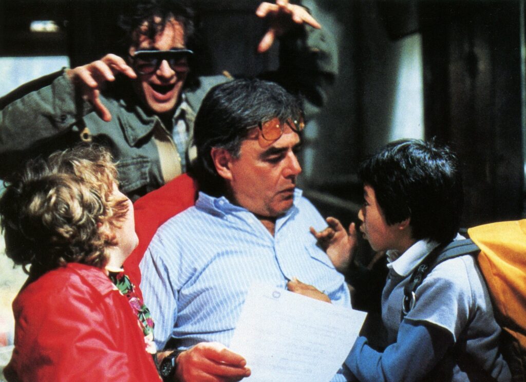 Richard Donner on the set of The Goonies (1985) with Executive Producer Steven Spielberg and actors Jeff Cohen and Ke Huy Quan