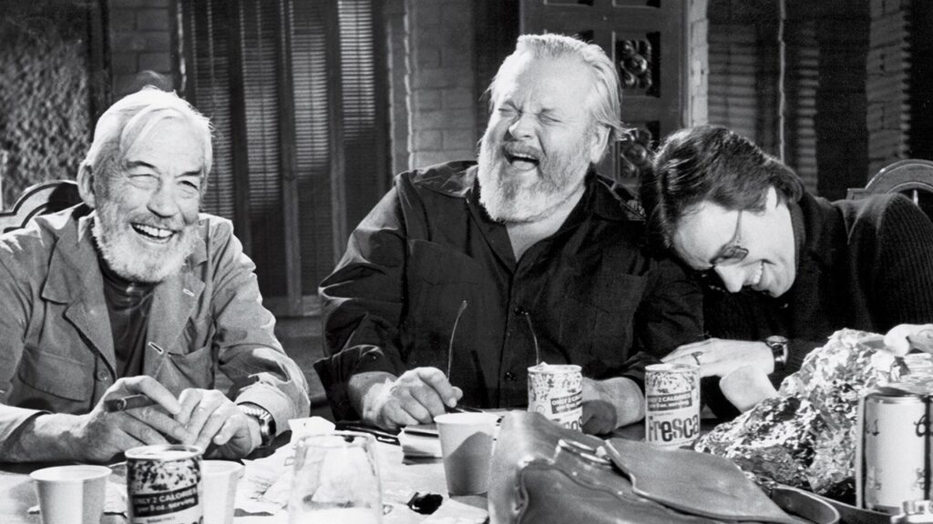 Filmmakers John Huston, Orson Welles and Peter Bogdanovich share a good laugh