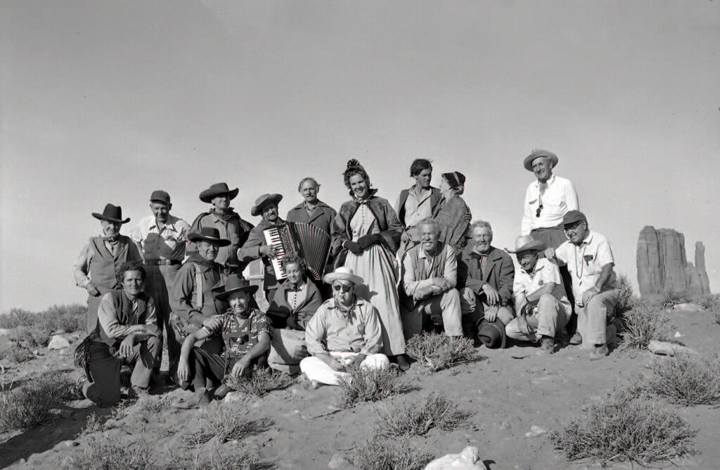 John Ford (Centre) with assorted cast and crew on the set of The Searchers (1956)