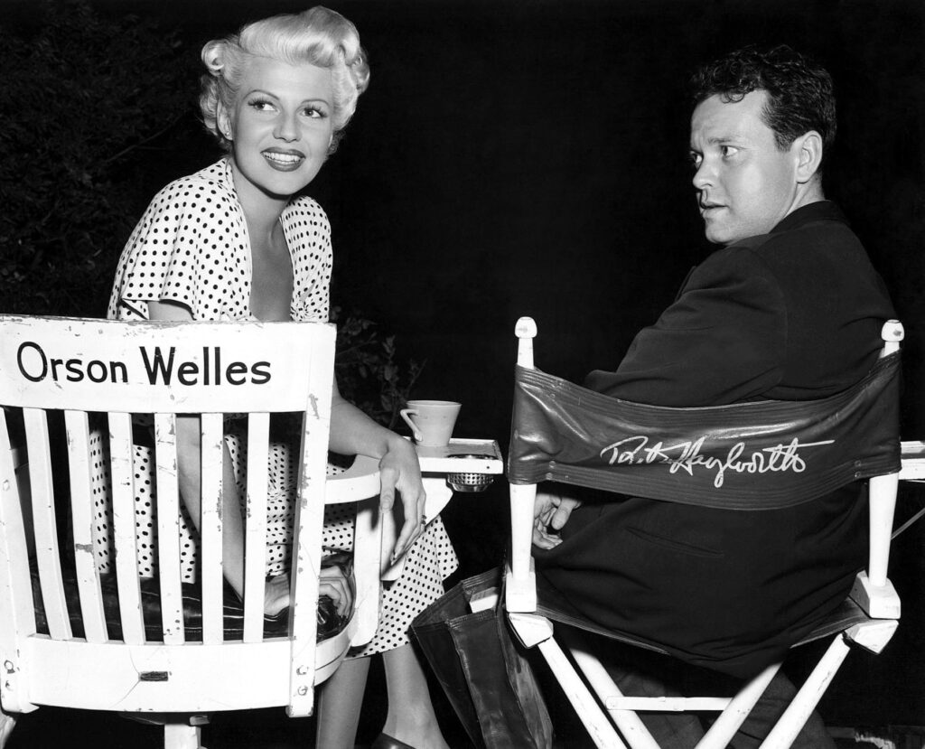 Rita Hayworth and Orson Welles swap seats on the set of The Lady From Shanghai (1947)