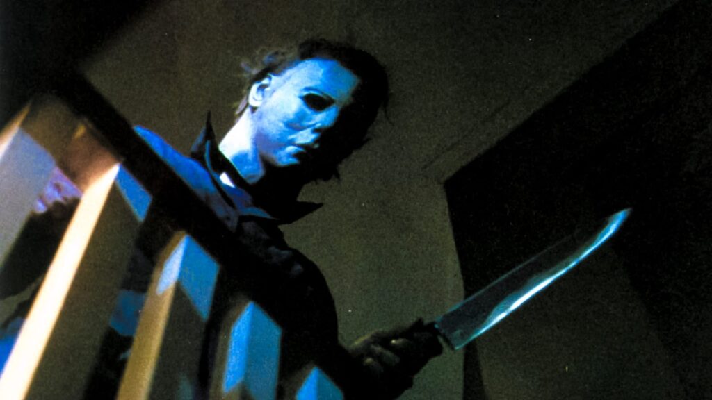 The evil Michael Myers looms over another victim with his trademark mask and carving knife!