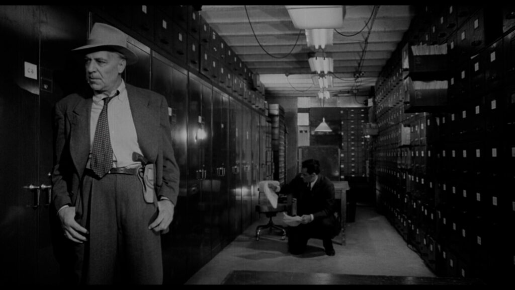 A deep focus shot of Vargas in the archives in Touch of Evil