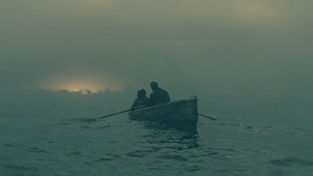 Kee and Theo escape into the mist in a row boat in Children of Men (2006)