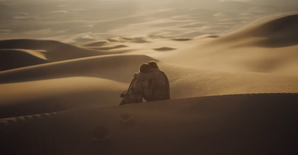 Paul and Chani embrace in Dune Part Two (2024)