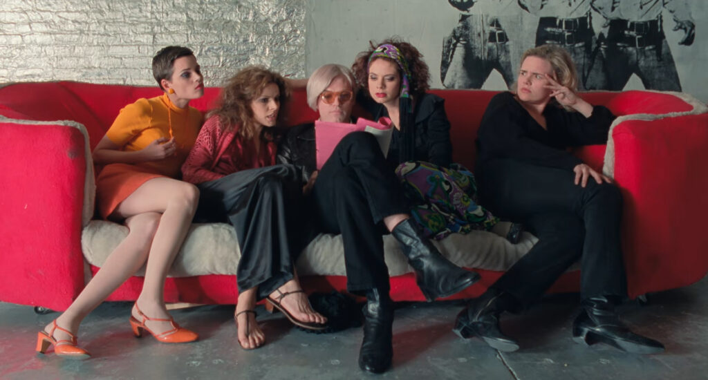 Andy Warhol and his coterie read Up Your Ass in I Shot Andy Warhol (1996)